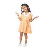A little girl in orange gingham dress with faux-lapel closure and hand embroidered kantha work on collar