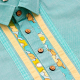 Close up of teal patchwork shirt with wood buttons