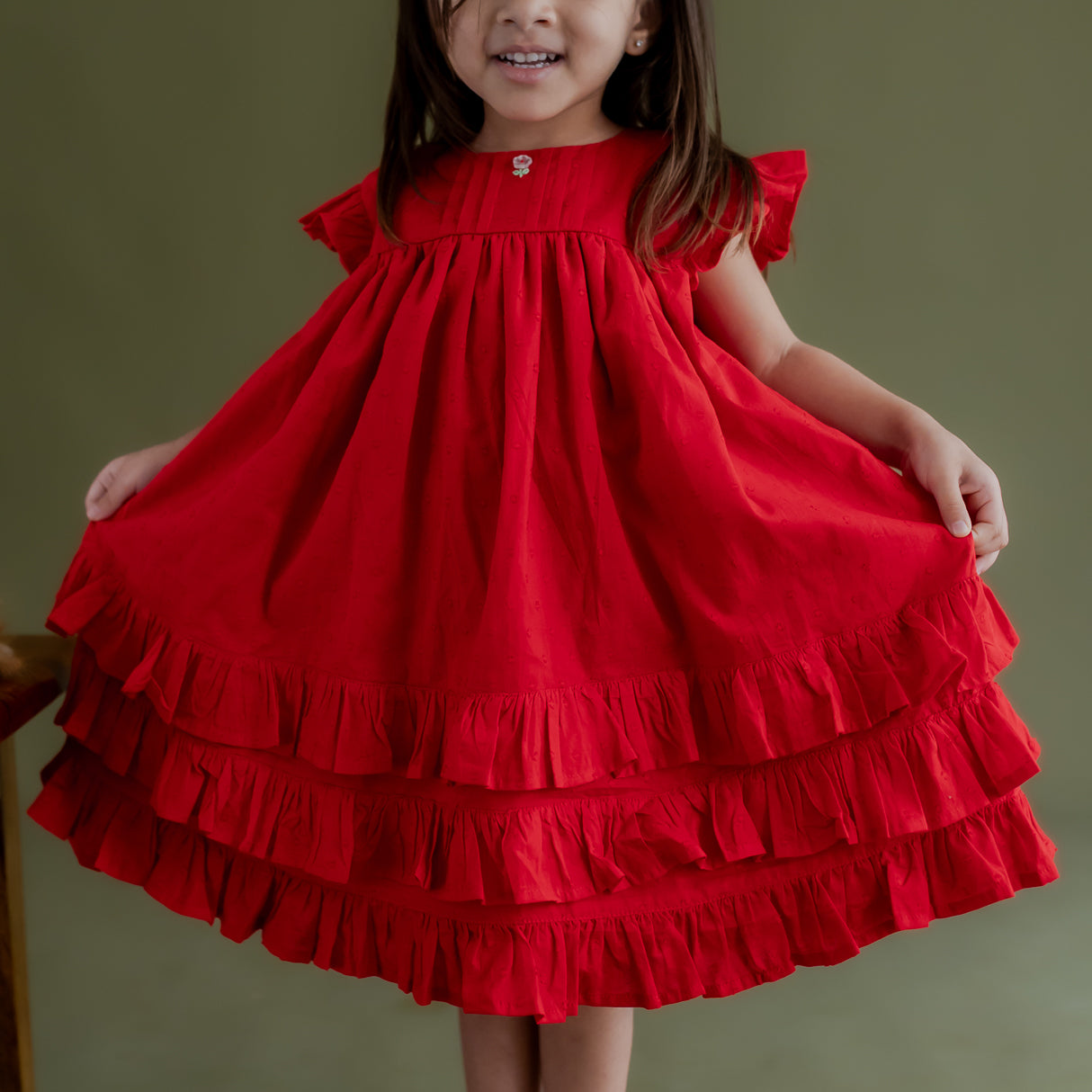 closeup of the triple layer ruffle hem of the red swiss dot dress