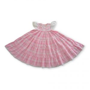 Flatlay of pink plaid nightgown with empire waistline with the skirt flowing in gathered tiers and delicate lace trims