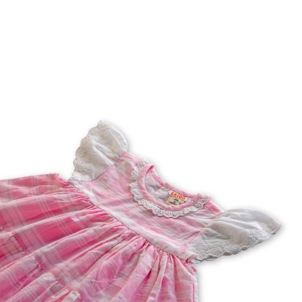 Flatlay of pink plaid nightgown with empire waistline and gathered skirt tiers featuring lace on neckline and sleeves