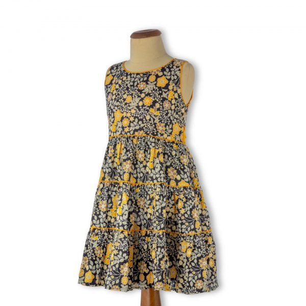 Mannequin with black and yellow floral print tiered skirt girls dress