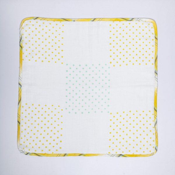Flatlay of absorbent gauze baby burp cloth in block-printed cotton fabric piped with accent plaid fabric