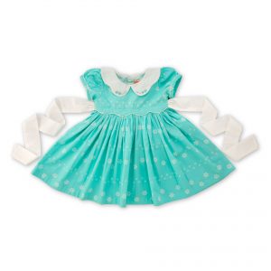 Flatlay of a girls dress in a sky blue with white scallop waistline and white back ties