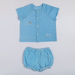 Flatlay of a hand embroidered blue raglan sleeve jabla with a matching striped blue bloomers
