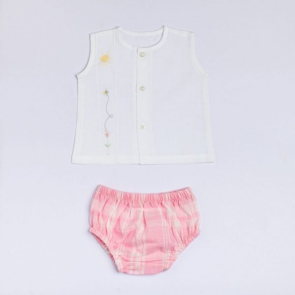 Flatlay of white muslin jabla with front buttons and hand embroidered design paired with pink checked bloomers