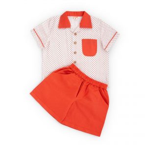 Flatlay of orange shorts and printed white cotton shirt set