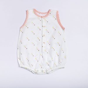 Flatlay of star print onesie with neon pink stripe piping, front open placket and button fastening