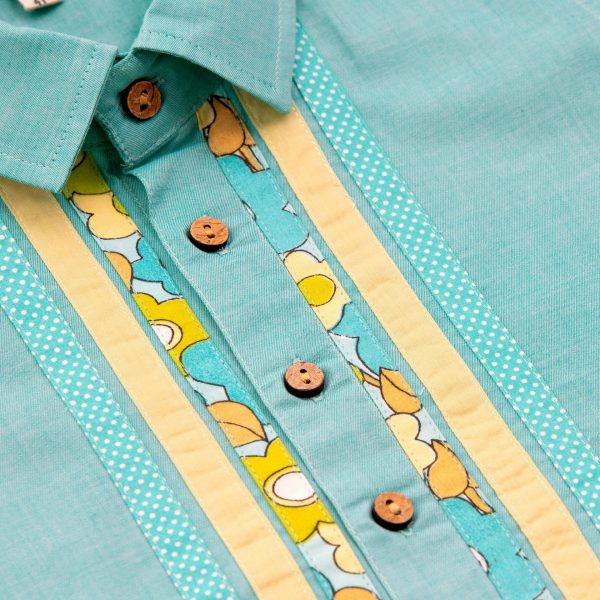 Close up of teal patchwork shirt with wood buttons