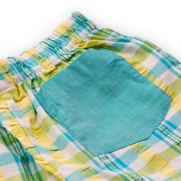 Close up of a solid back pocket on a teal and yellow plaid shorts