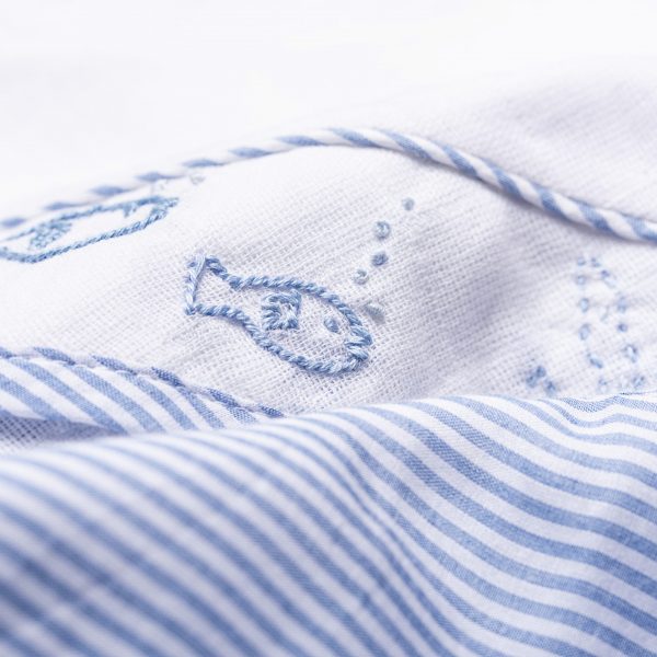 Embroidery of a fish on a muslin band