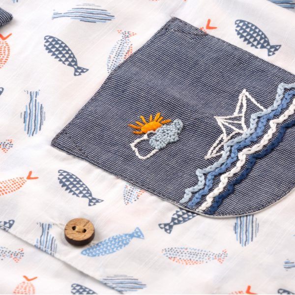 Close-up of the hand embroidered pocket in fish printed cotton shirt