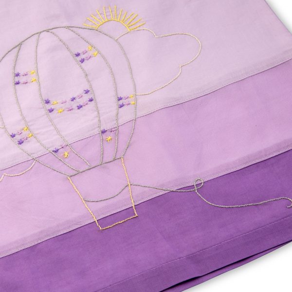 hand embroidered hot air balloon in shades of yellow over a lavender ombre base