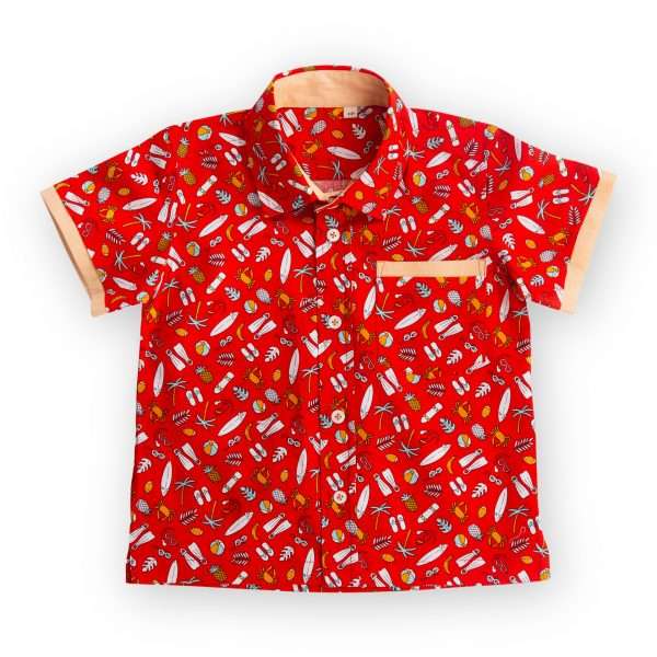 Flatlay of red printed shirt with coordinated fabric bands stitched underneath the pocket and sleeve hems