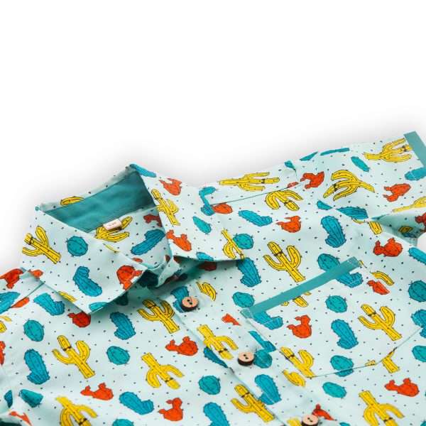 Close-up of cacti printed teal cotton boys' shirt with a pocket