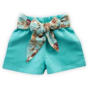 Flatlay of aqua blue shorts with elasticated paperbag waistline, side pockets, reversible fabric waist belt