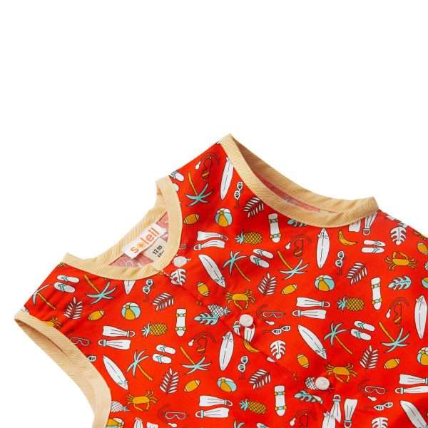 Close-up of red onesie with a round neckline, front button placket and an all-over fun print