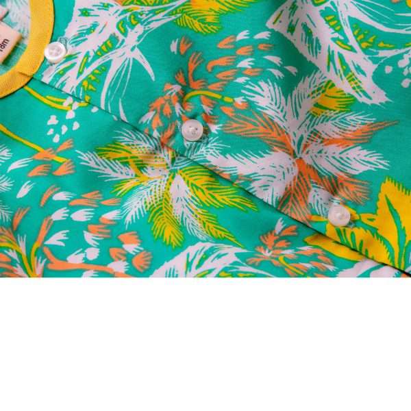 Palm tree print infant onesie shown partially with a portion of the neckline piped in yellow