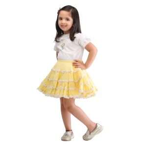 A little girl in embroidered white ruffle blouse and yellow umbrella skirt