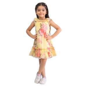 A little girl in yellow rose print chiffon dress with ruffled hem and raglan puff sleeves