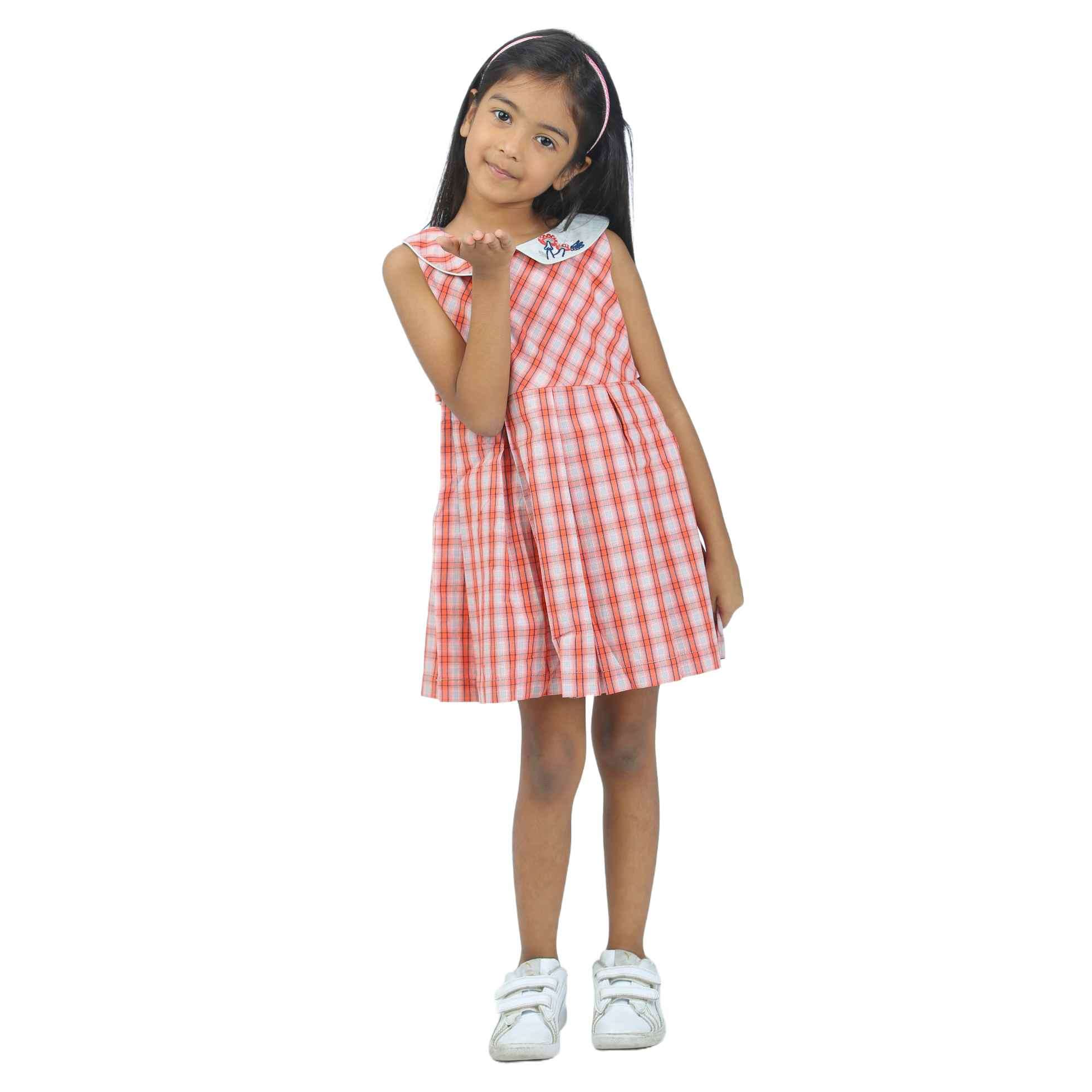 Girl wearing a red and ivory plaid casual dress with collar embroidery