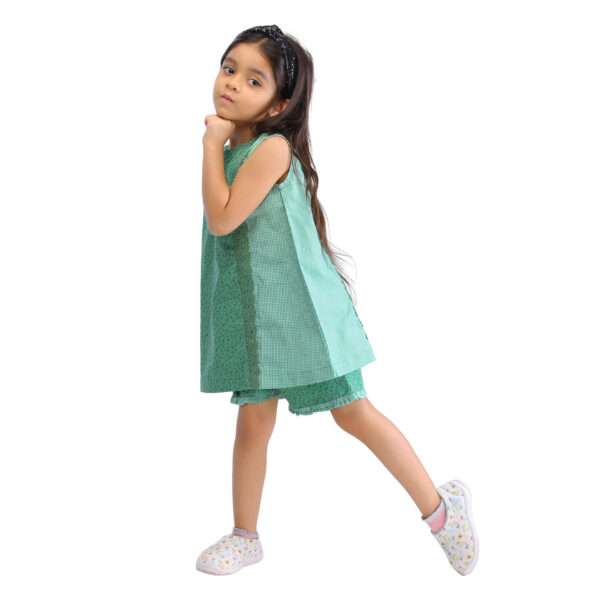 A girl striking a pose in Lust Green Forest tunic and shorts set