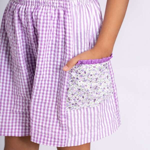 Lavender shorts with a little hand in the floral pocket with cute little ruffles on it