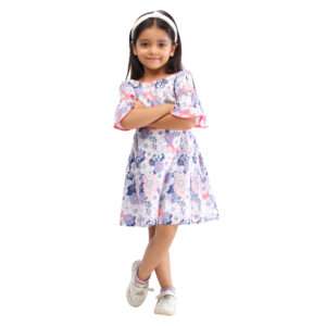 A little girl in swiss dot pink and blue floral printed cotton dress with bell sleeves
