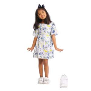 A young girl wearing swiss dot blue floral printed cotton dress with boat neck and elasticated shirring on bell sleeves