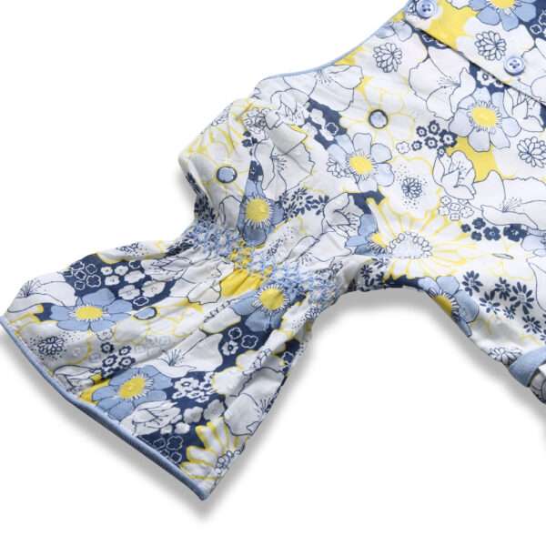 Close-up of elasticated shirring on bell sleeves in swiss dot blue floral printed cotton dress