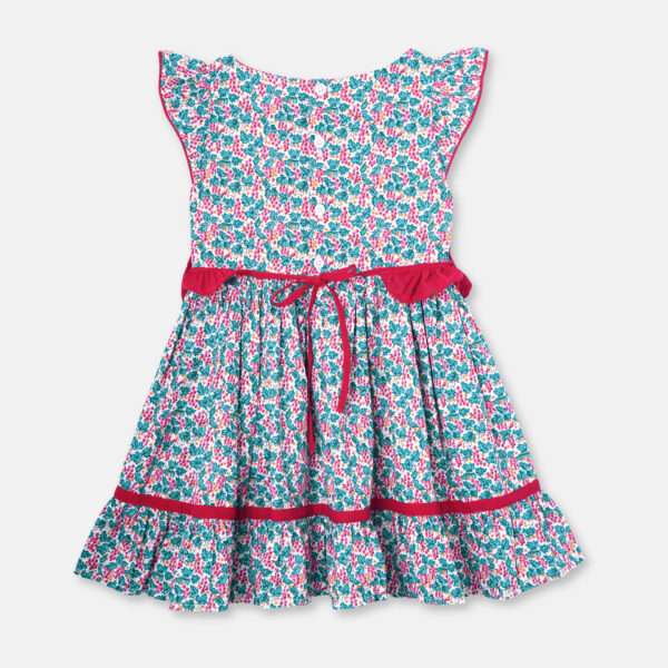 Flatlay of red and green floral printed cotton dress with a tie up fabric ruffle belt