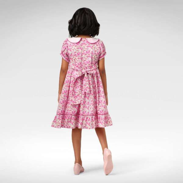 Back view of pink floral fit and flare dress with a pink collar