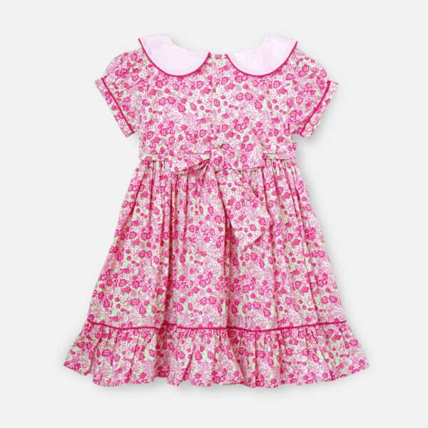 Pink floral girls dress withback ties and a solid pink collar and heavily gathered sleeves