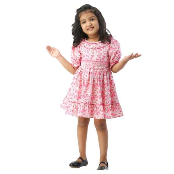 Girl in pink floral cotton dress with a hand smocked waistline and ruffled collar