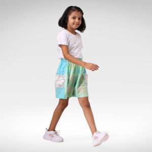 A little girl in breezy plaid cotton shorts with solid sea-blue linen side panels and a faux-crochet pocket on each side