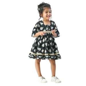 Girl weras a black and white floral print dress with elbow length sleeves and lace trims