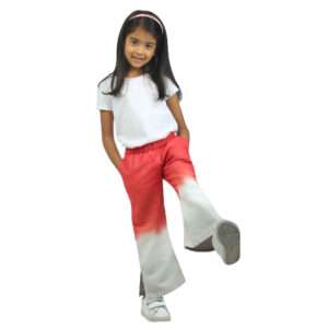 A little girl in coral and grey tie dye bootleg pants with elastic waistband lined with cotton and with side pockets