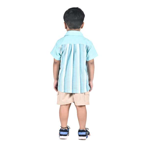 A boy in turquoise blue chambray half sleeve cotton shirt with stripes in shades of blue and a spacious chest pocket