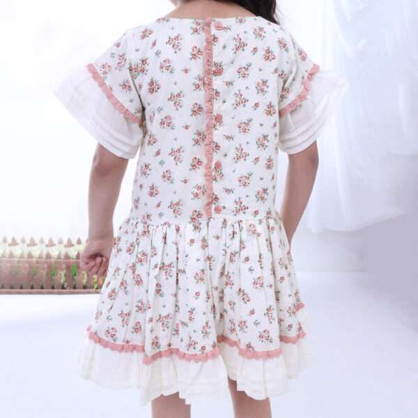 A little girl in drop waist cotton floral dress