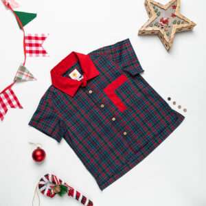Flatlay of green and red tartan checked shirt with double pocket paired with tan cargo shorts