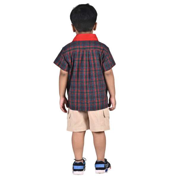 Rear image of a little boy in red and green tartan shirt with double pocket