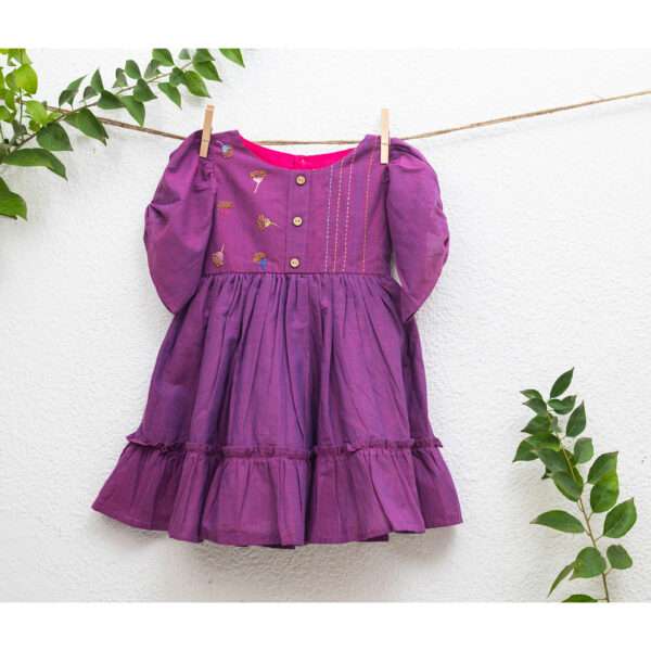 A hanger image of magenta cotton "sparkler" dress with intricate bead embroidery