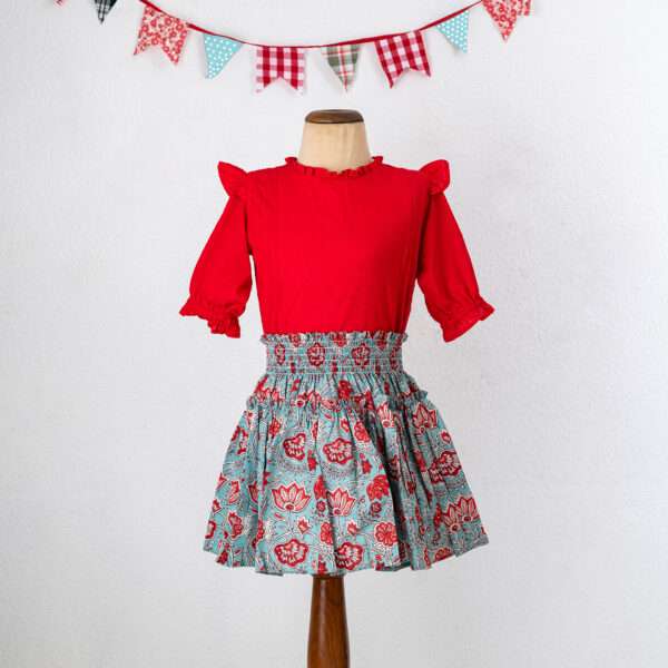 Shirred india print skirt and bright red swiss dot blouse set on a mannequin
