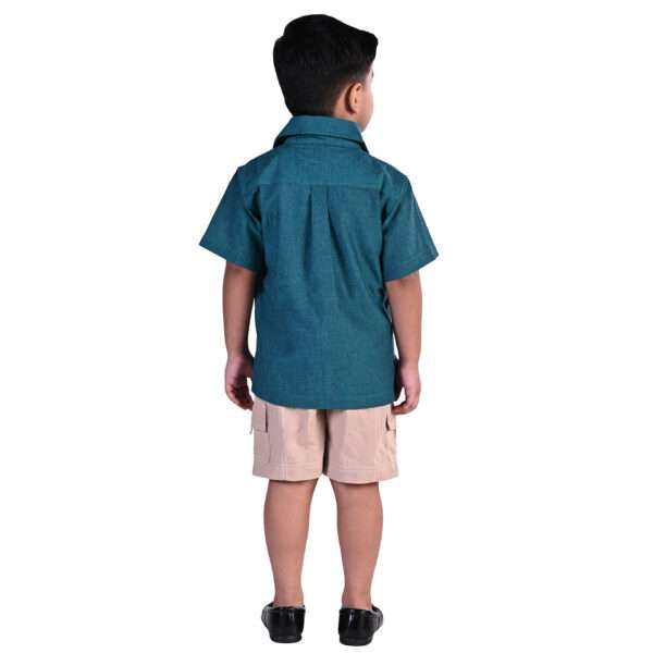 Rear image of a little boy in sparkler green chambray shirt with kantha embroidery on collar and tan cargo shorts