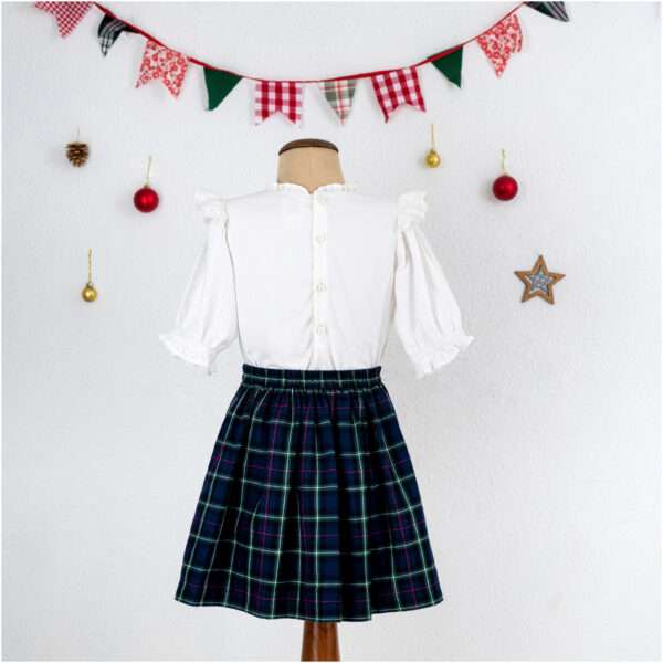 Girls tartan skirt and white lace blouse set on a mannequin