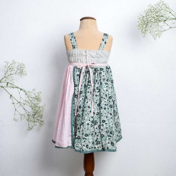 Mannequin image of strappy dress with floral print and pink dot fabric with intricate ribbon patchwork heart applique