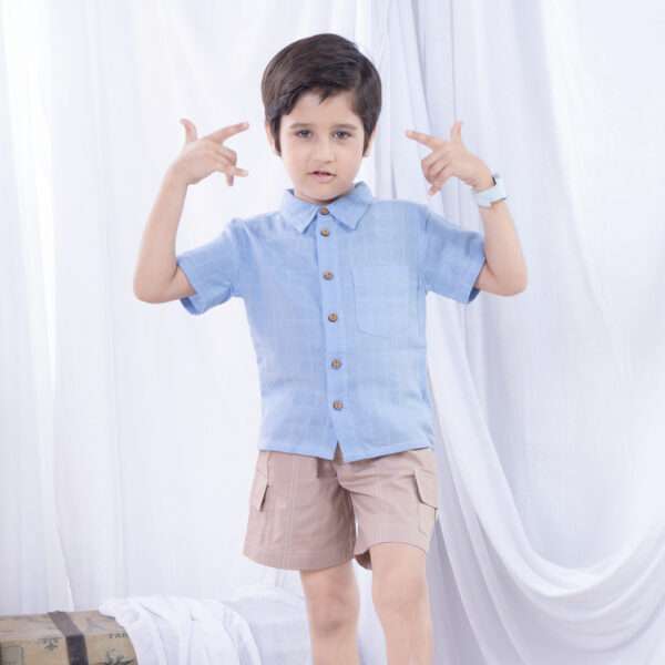 Boy models an aqua gauze shirt and khaki shorts