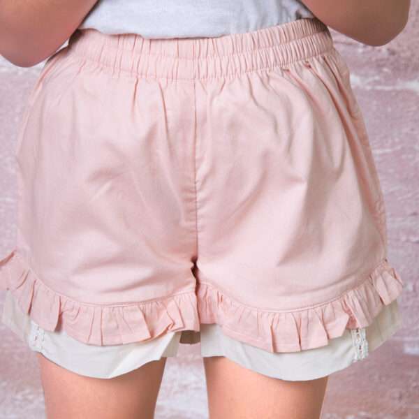Close-up of double ruffle peach shorts with lace trims, soft elastication