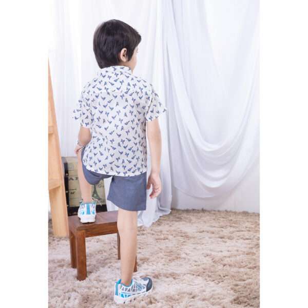 Rear side of a boy posing in soft cotton bird printed collared shirt with contrast blue buttons