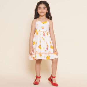 A little girl in pink vibrant fruit print dress with lemons, tangerines and daisies and orange gingham trims